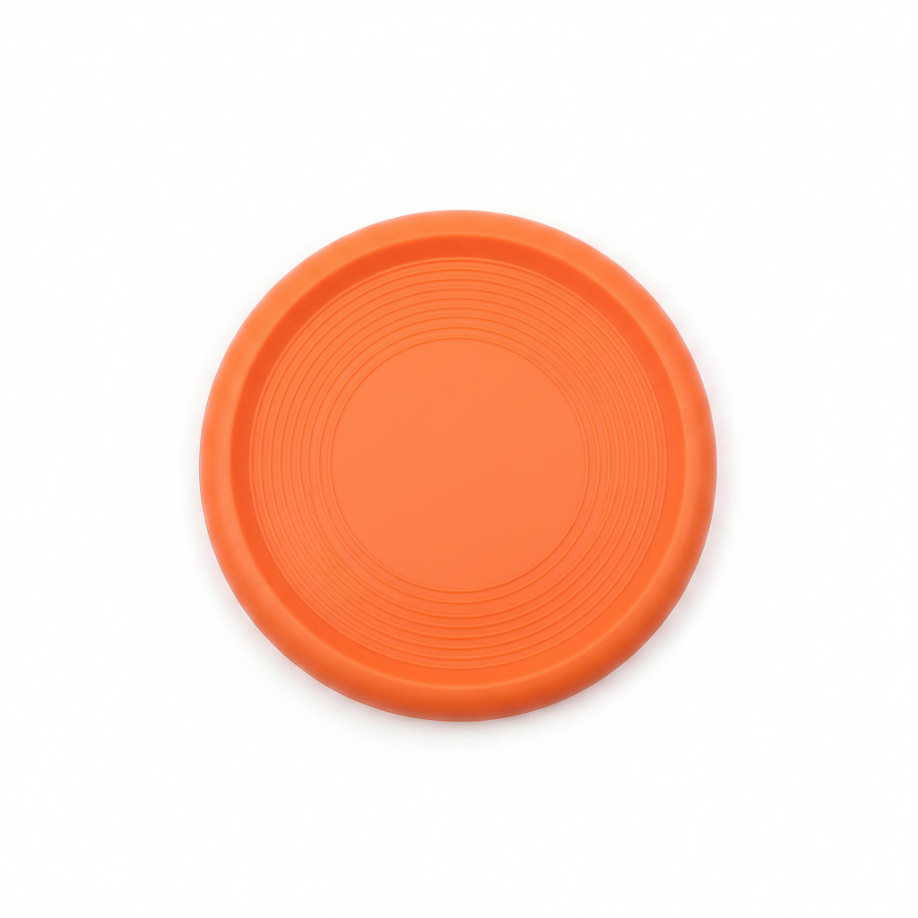Orange rubber dog frisbee flat lay top-down view on white background